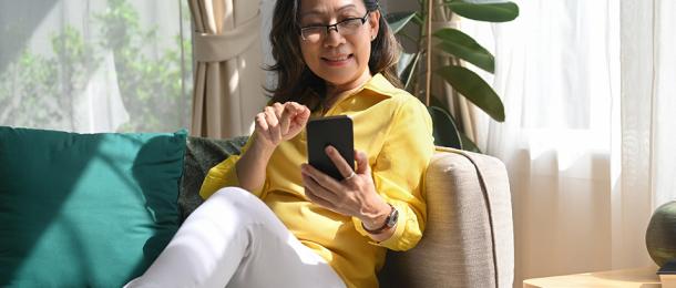 A woman looking at her phone screen - RemServ Salary Sacrifice